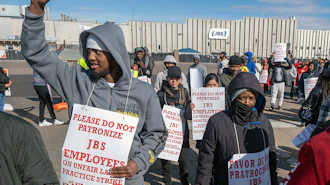 Workers from the JBS Beef Plant protest across the road from the plant on March 16, 2026 in Greeley, Colo.