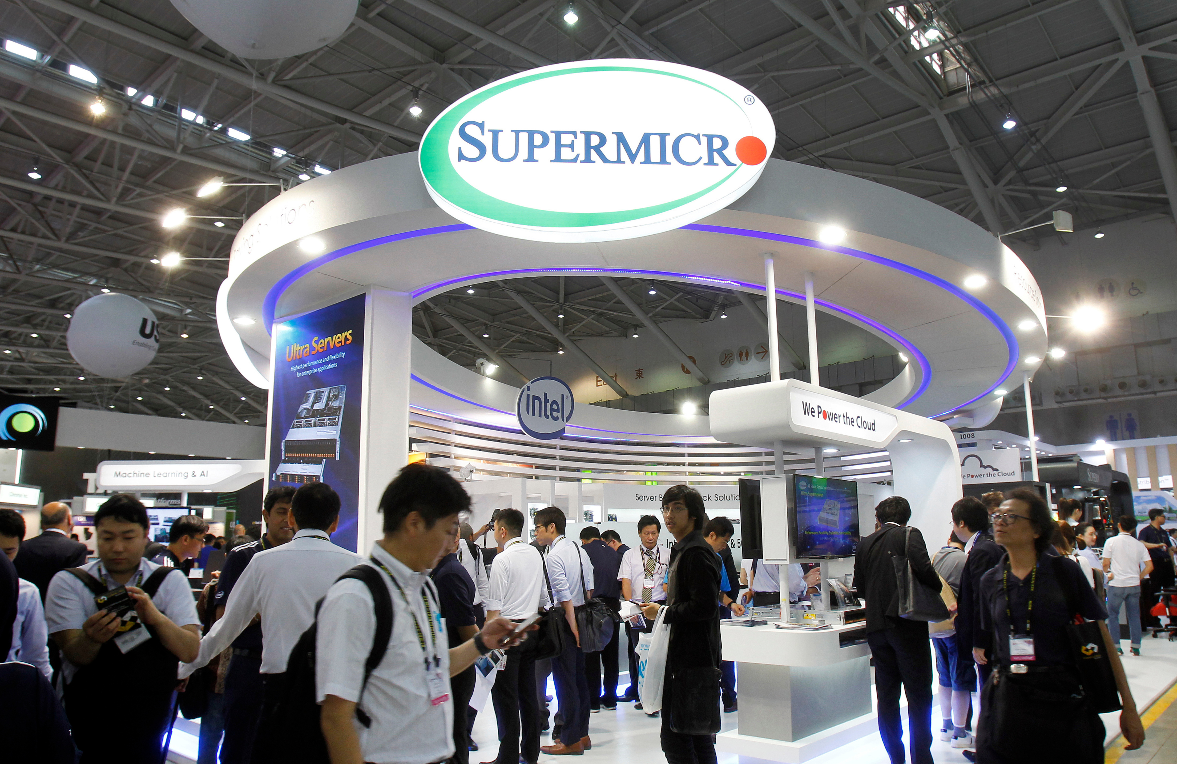 Visitors walk past a Super Micro Computer Inc. booth at the Computex Taipei exhibition in Taipei, Taiwan, June 5, 2018.
