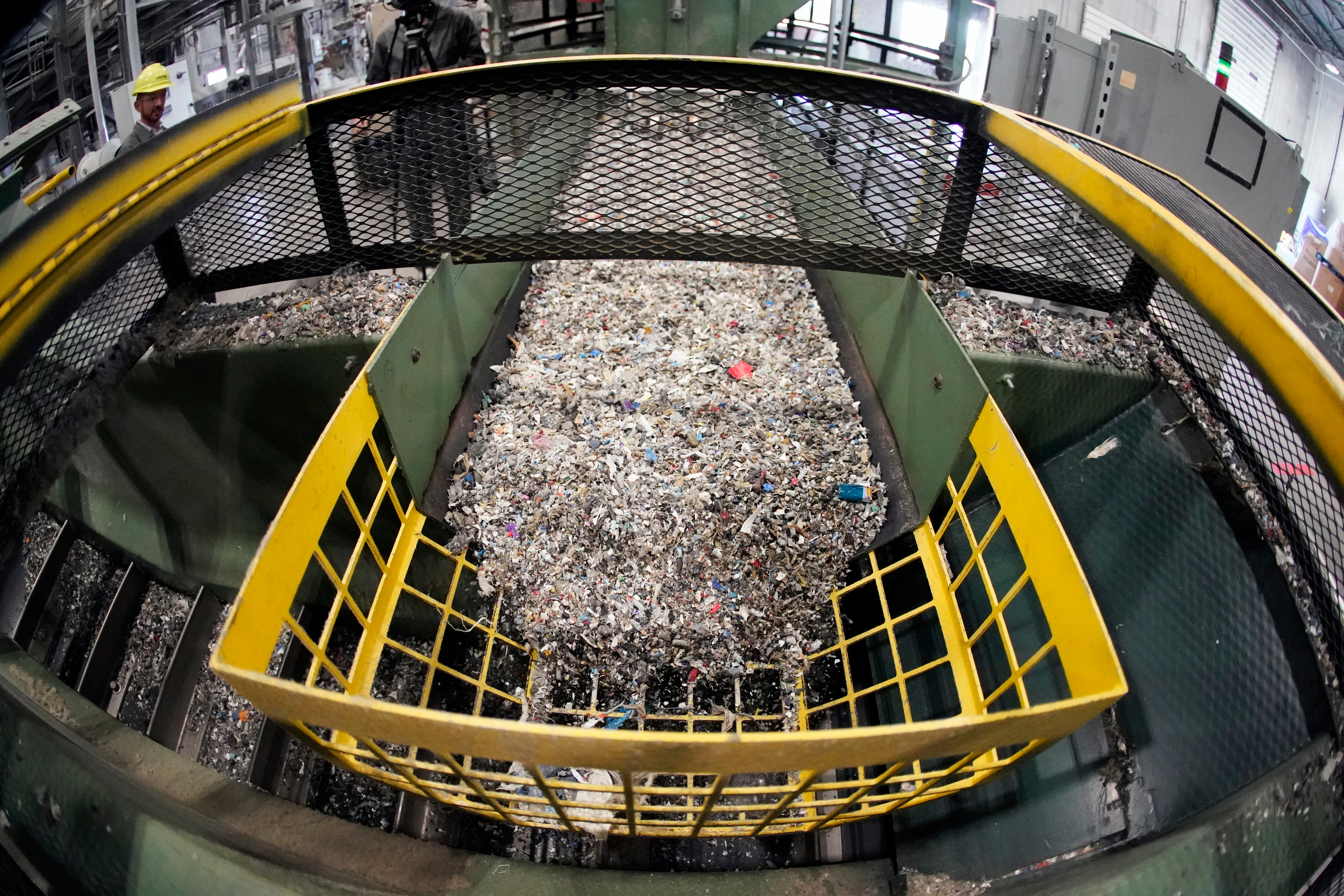 Ground up plastics that Alterra Energy receives from recycling facilities, move along a conveyor at the start of their process that transforms the material into a liquid that is then used in the manufacturing of plastic in Akron, Ohio, Sept. 8, 2022.
