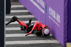 A robot crashes against a board after crossing the finish line in the Beijing E-Town Half Marathon and Humanoid Robot Half-Marathon held in the outskirts of Beijing, Sunday, April 19, 2026.