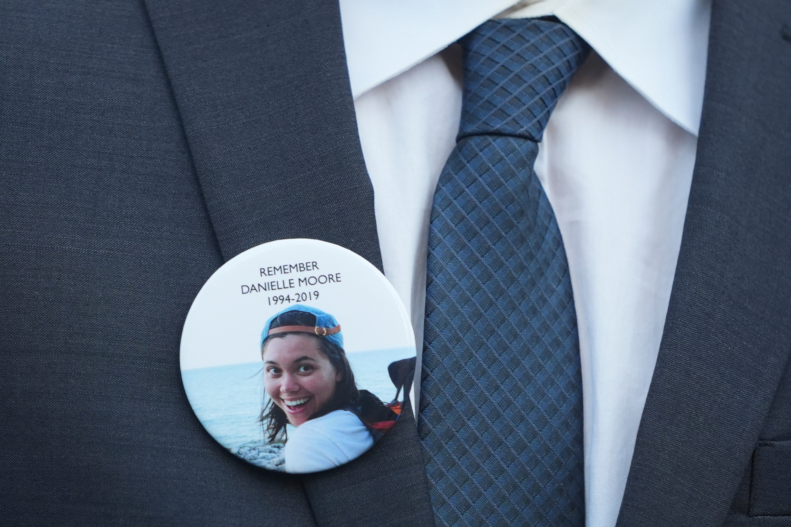 A family member wears a photo of a Boeing crash victim Danielle Moore before a hearing at federal court in Fort Worth, Texas, Sept. 3, 2025.