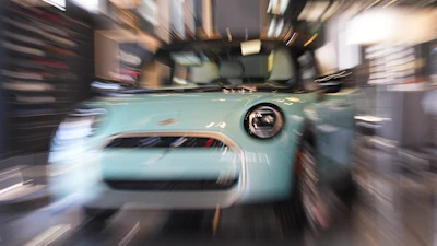 Made with a slow shutter speed and zoom lens, an unsold 2026 Cooper S hardtop is diplayed in a Mini dealership Friday, Oct. 24, 2025, in Highlands Ranch, Colo.