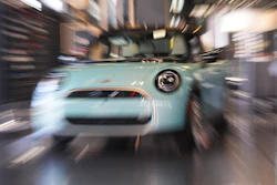 Made with a slow shutter speed and zoom lens, an unsold 2026 Cooper S hardtop is diplayed in a Mini dealership Friday, Oct. 24, 2025, in Highlands Ranch, Colo.