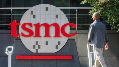 A worker walks past the logo of TSMC or Taiwan Semiconductor Manufacturing Corp., a Taiwanese multinational semiconductor contract manufacturing and design company, in Hsinchu, Taiwan, on Thursday, Jan. 29, 2026.