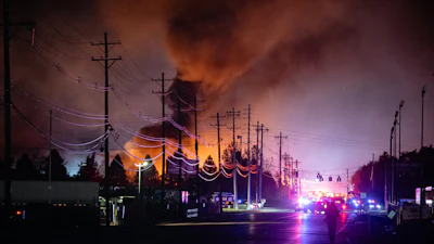 Plumes of smoke rise from the area of a UPS cargo plane crash at Louisville Muhammad Ali International Airport, Nov. 4, 2025, in Louisville, Ky.