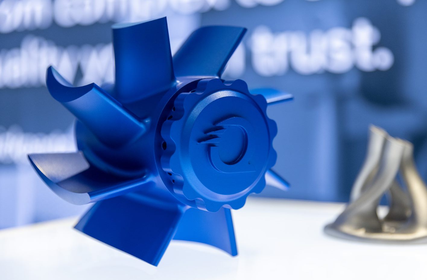 A blue CNC part created by Quickparts.