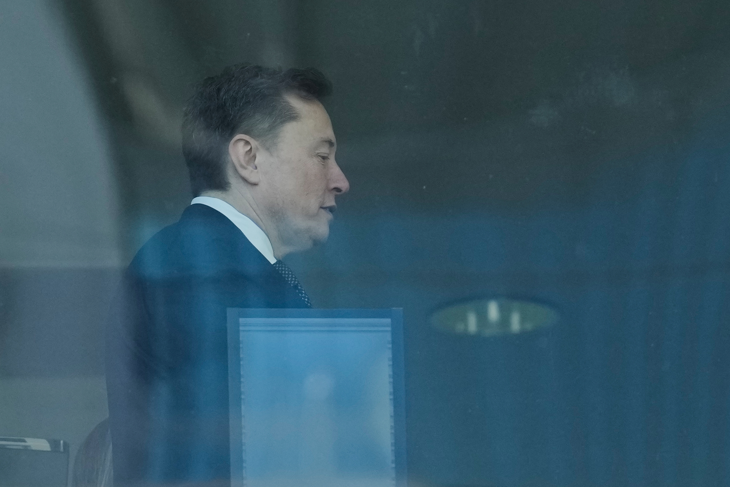 Elon Musk walks through a hallway inside the U.S. District Court in Oakland, Calif., Wednesday, April 29, 2026.