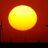 Wind turbines are silhouetted against the sky at sunset May 15, 2026, near Cimarron, Kan.