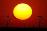 Wind turbines are silhouetted against the sky at sunset May 15, 2026, near Cimarron, Kan.