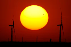 Wind turbines are silhouetted against the sky at sunset May 15, 2026, near Cimarron, Kan.