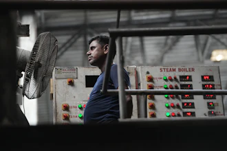 A worker stands in front of a fan on a hot day at Vinit Fabrics in Palsana near Surat, India, Tuesday, May 26, 2026.