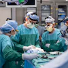Dr. Matthew Willsey (middle) secures the Connexus BCI after implantation.