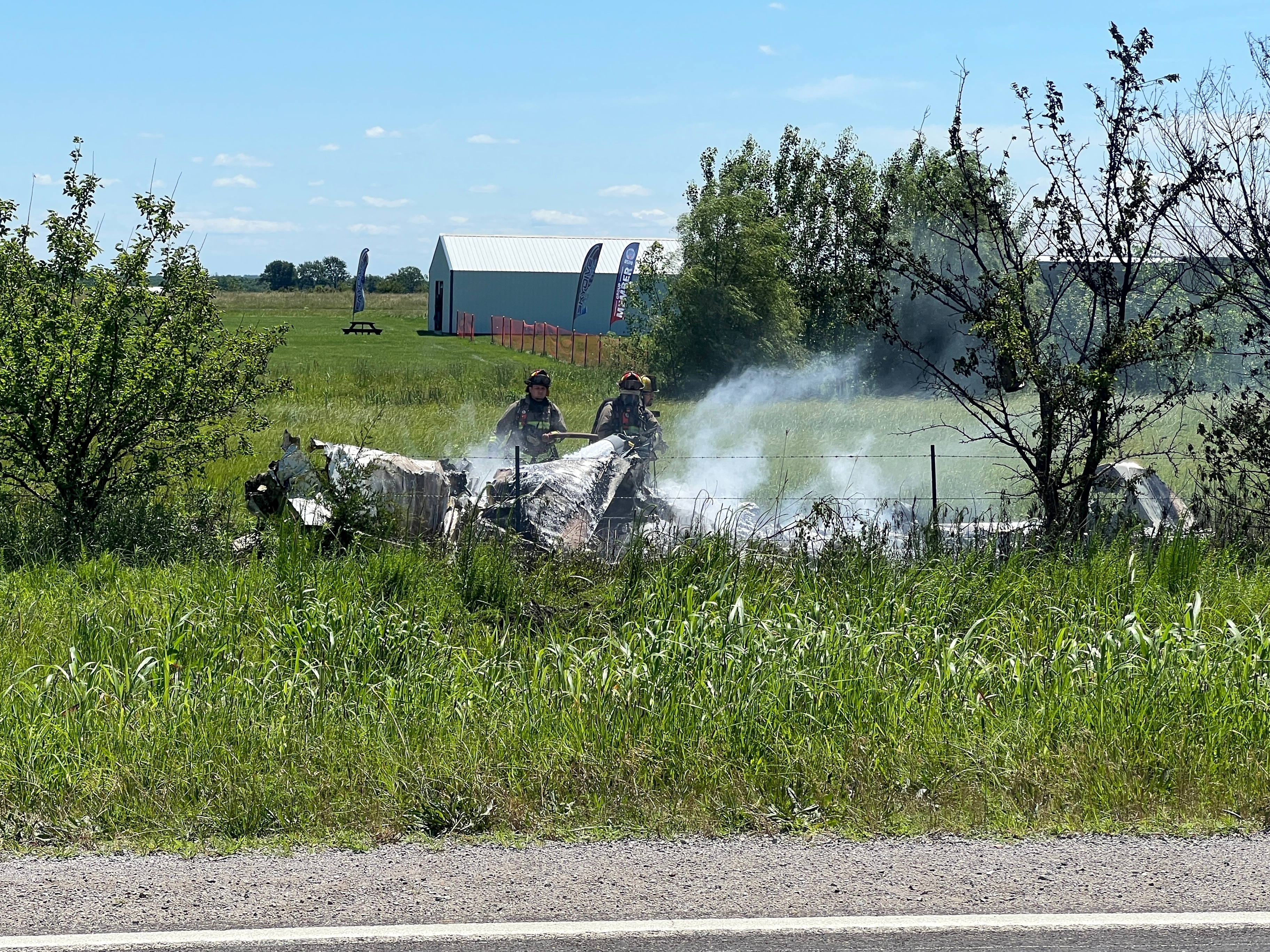The wreckage of a plane crash burns in a field in Butler, Mo, Sunday, June 14, 2026.