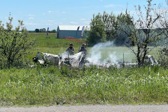 The wreckage of a plane crash burns in a field in Butler, Mo, Sunday, June 14, 2026.