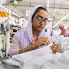 Ruma Aktar, a sewing machine operator, wears her prescription eyeglasses while working at a garment factory in Gazipur, on the outskirts of Dhaka, Bangladesh, June 30, 2026.