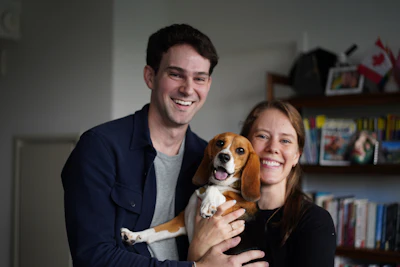 Matt and Maggie Walker pose for a photo with their gene-edited hypoallergenic beagle, Bailey, in New York on Aug. 4, 2026.