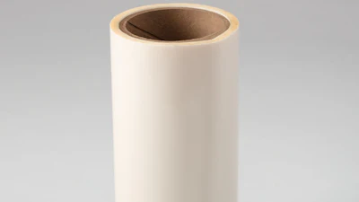 Empty cream-colored cylindrical cardboard tube with brown interior on neutral background