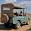 In this photo taken with a smartphone, an electric safari van operated by Emboo Camp drives through the Maasai Mara, Kenya, Saturday, Aug. 29, 2026.