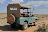 In this photo taken with a smartphone, an electric safari van operated by Emboo Camp drives through the Maasai Mara, Kenya, Saturday, Aug. 29, 2026.
