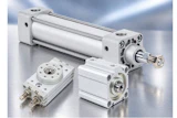 Industrial pneumatic cylinders and compact actuators with metal fittings displayed on reflective surface