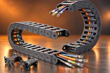 Industrial cable management system with multi-colored wires in flexible drag chain housings against warm orange background