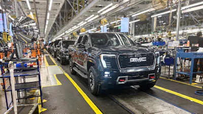 A GMC Sierra EV with battery cells made from recycled materials rolls off the line at GM’s Factory ZERO assembly facility.