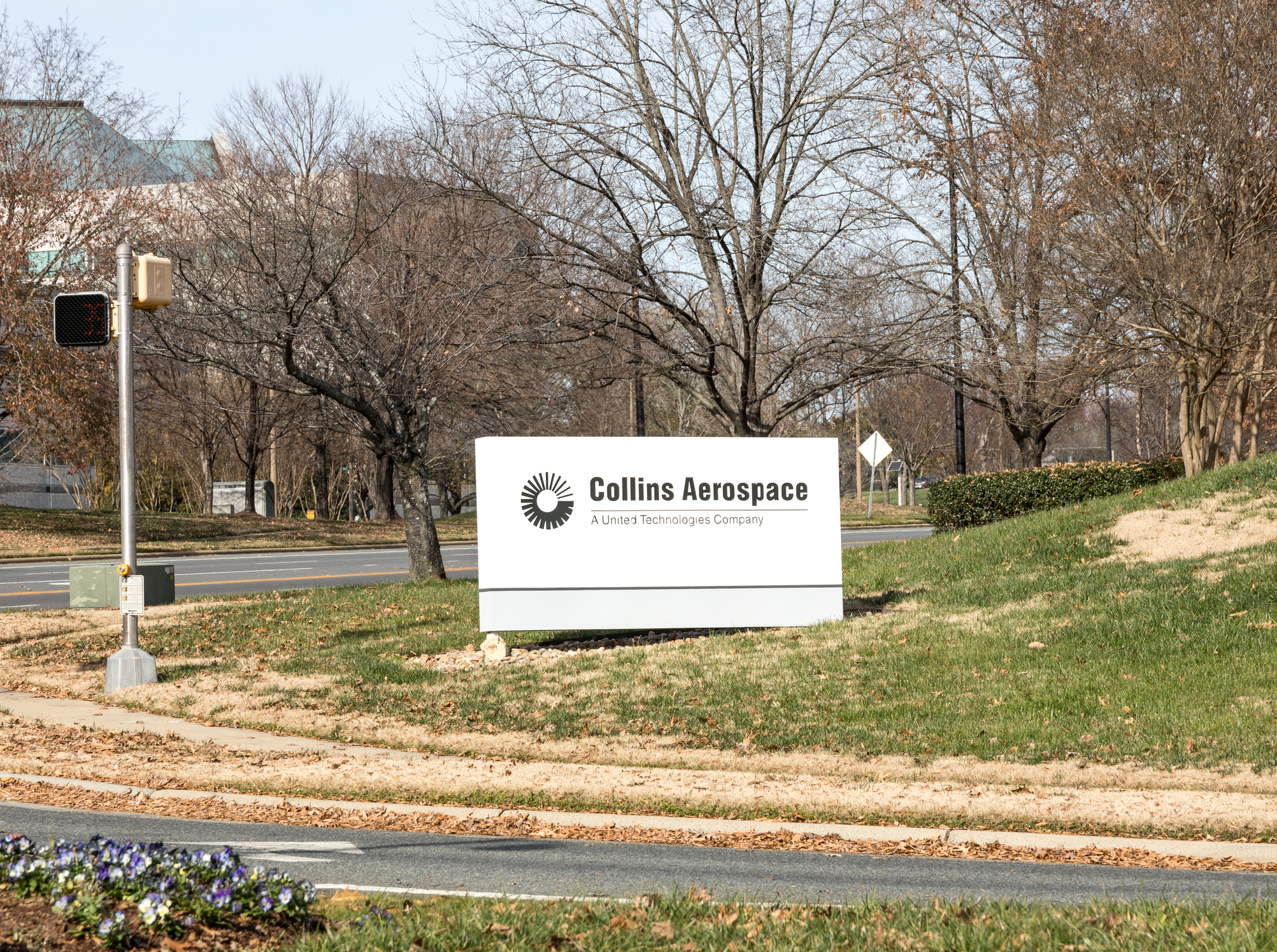 Collins Aerospace corporate sign on landscaped grounds with bare trees and road