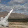 A Northrop Grumman-built solid rocket motor powering a Guided Multiple Launch Rocket System (GMLRS) missile for the U.S. Army.