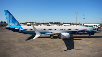 Boeing 737 commercial aircraft parked at airport with blue and white livery
