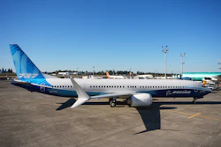 Boeing 737 commercial aircraft parked at airport with blue and white livery