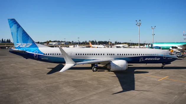 Boeing 737 commercial aircraft parked at airport with blue and white livery