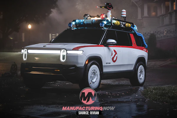 Rivian R1S electric SUV styled as Ghostbusters vehicle with roof-mounted equipment in nighttime urban setting