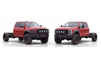 Two red lifted pickup trucks with custom front bumpers and roof lights displayed side by side