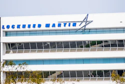 Lockheed Martin logo and text on modern white office building facade with blue glass windows