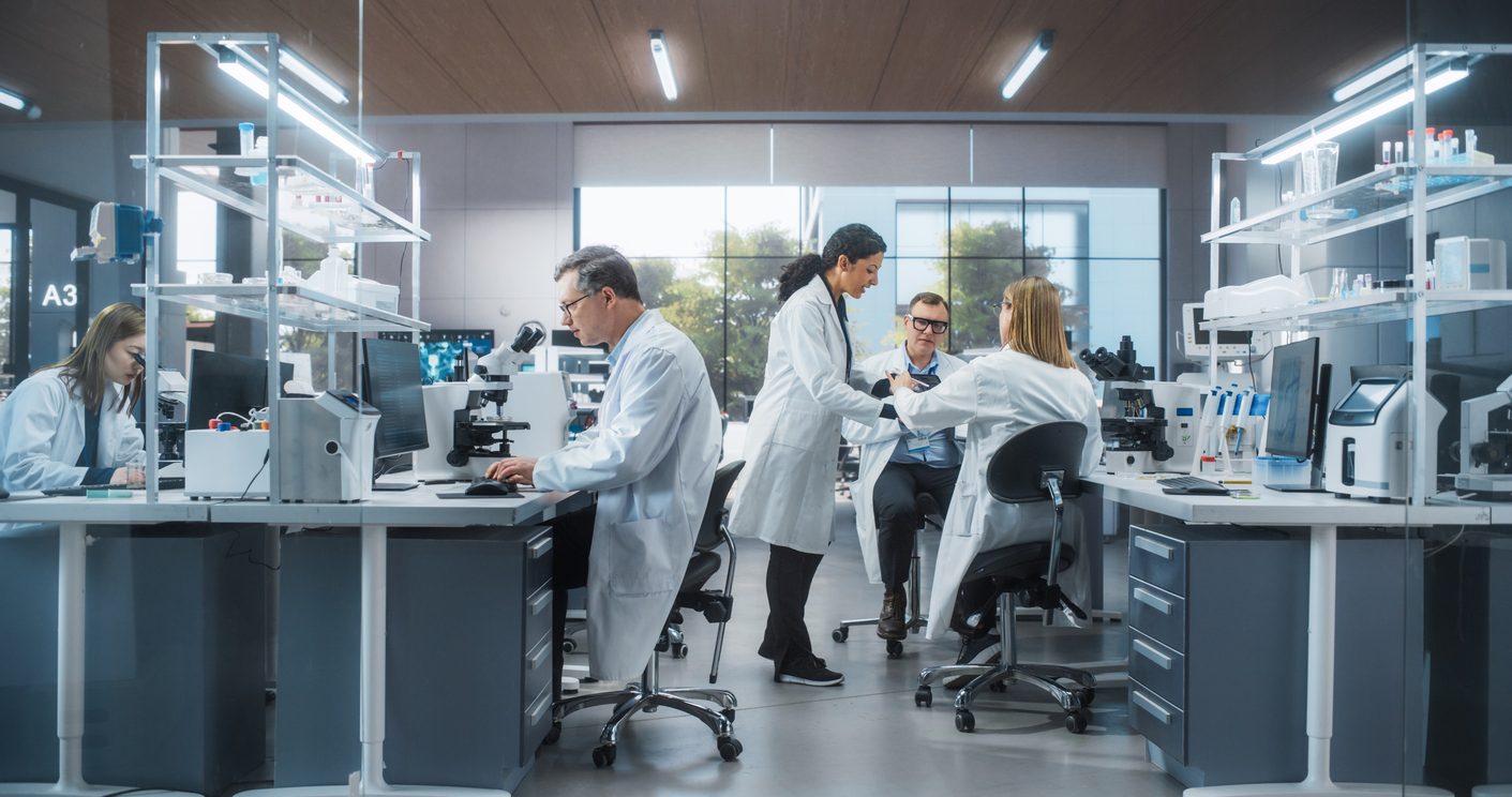 Scientists and technicians working in a modern laboratory with microscopes and analytical equipment