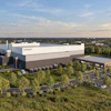 Hitachi corporate manufacturing facility with modern architecture, surrounded by landscaping and parking lot