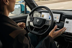 Driver with hands on steering wheel inside modern autonomous vehicle with digital dashboard display