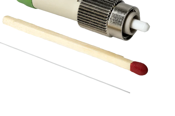 Fiber optic connector with green cable, metallic coupling nut, and ceramic ferrule tip displayed with applicator tools