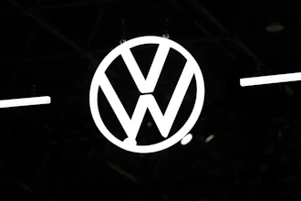 Volkswagen logo emblem illuminated against dark background